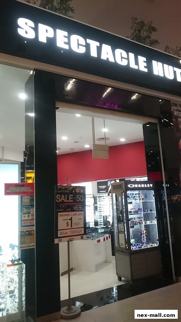 The entrance of Spectacle Hut NEX, showcasing a sale on frames and lenses.
