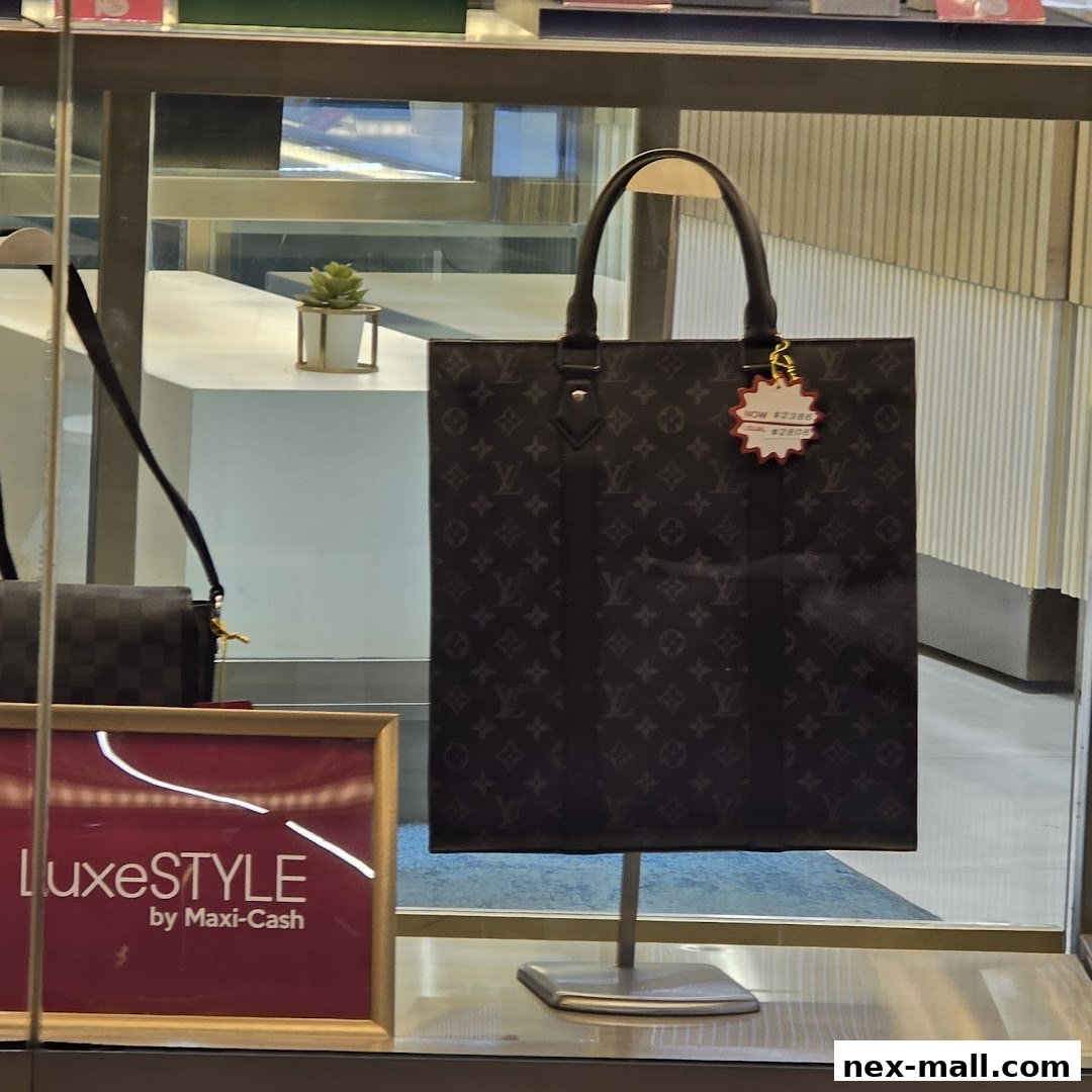 A display window featuring a branded tote bag and a smaller handbag, with a price tag visible.