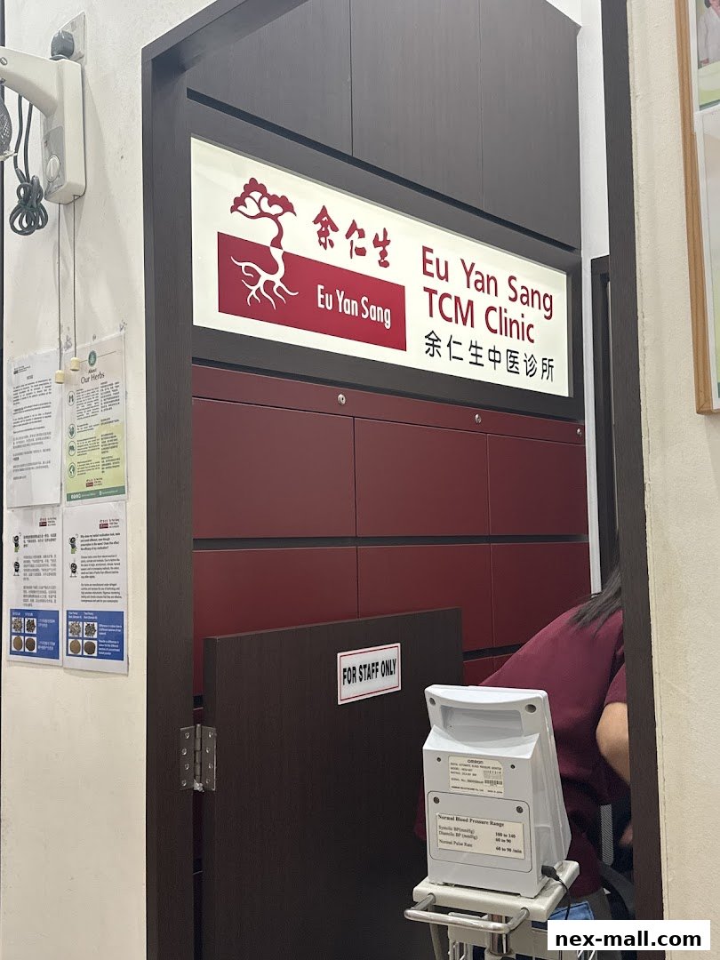 The entrance to Eu Yan Sang TCM Clinic with its signage and a blood pressure monitor.