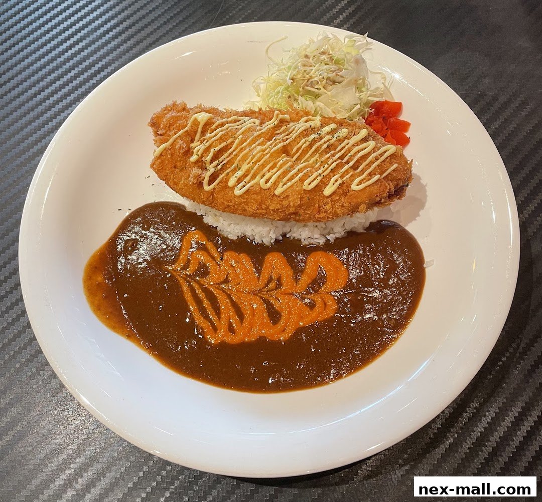A delicious plate of Japanese curry with crispy fried fish and rice.