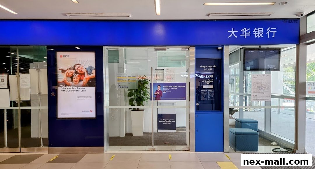 The entrance to a UOB bank branch with promotional posters and a cheque deposit machine.