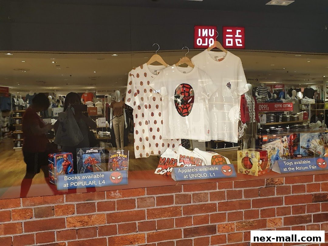 UNIQLO store window display featuring Marvel Spider-Man themed apparel and merchandise.