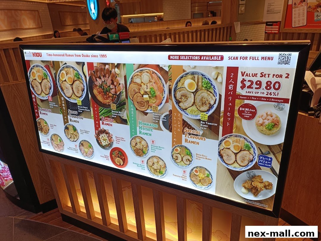 A brightly lit menu board showcasing various ramen dishes and a value set for two.