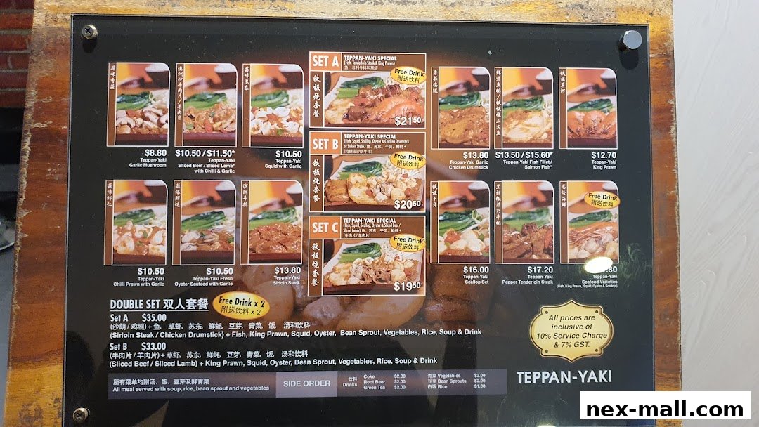 A menu board displaying various Teppan-Yaki sets and side orders with prices.