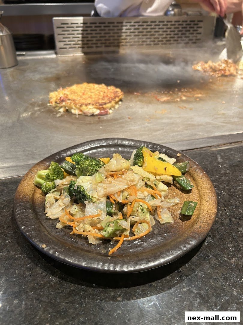 A plate of stir-fried vegetables served on a teppanyaki grill.