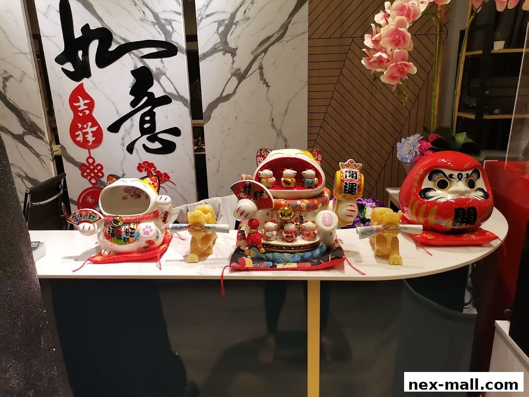 A display of traditional Japanese lucky charms including Maneki-neko cats and a Daruma doll.