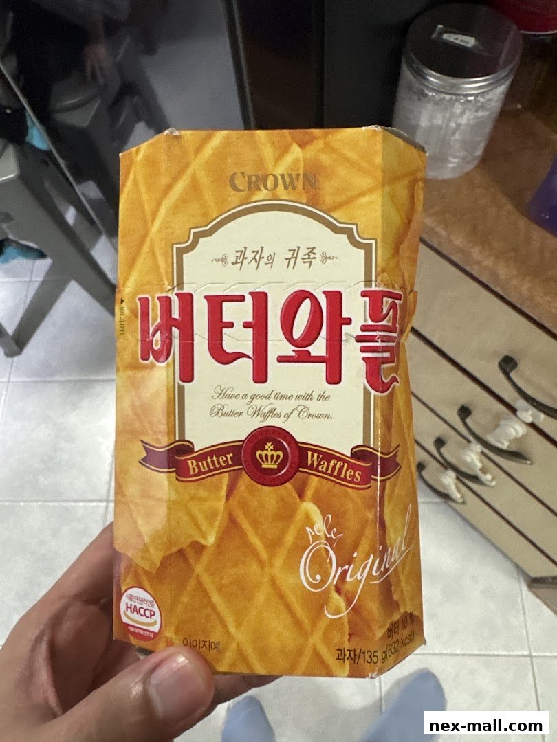 A hand holds a box of Crown Butter Waffles, featuring Korean text and waffle imagery.