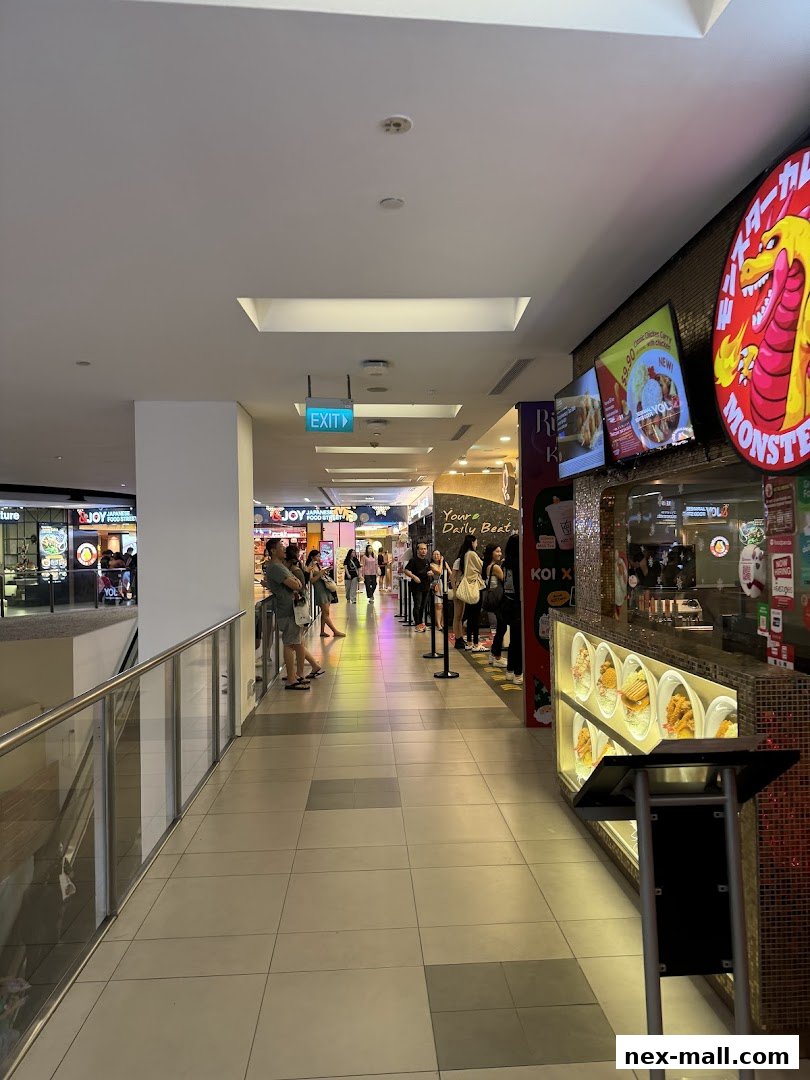 A queue of people waiting outside a KOI Thé shop in a mall.