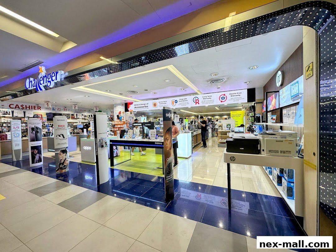 Interior view of a Challenger NEX electronics store showcasing various products and displays.