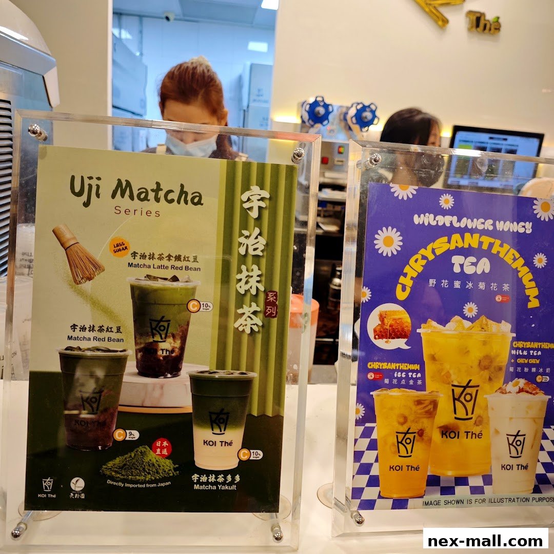 Two display boards showcasing KOI Thé's Uji Matcha and Chrysanthemum tea series.