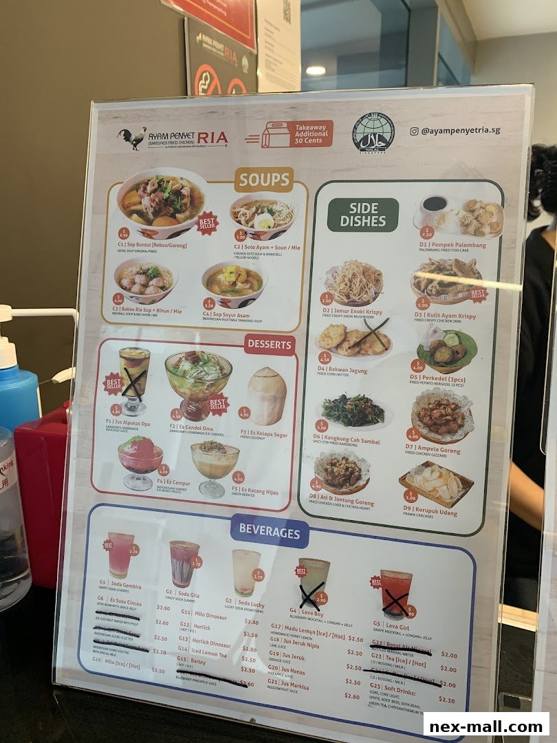 A menu board for Ayam Penyet Ria featuring soups, side dishes, desserts, and beverages.