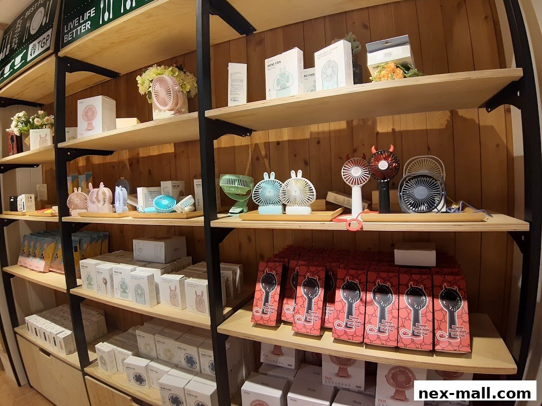 Shelves filled with various portable fans and decorative items in a retail store.