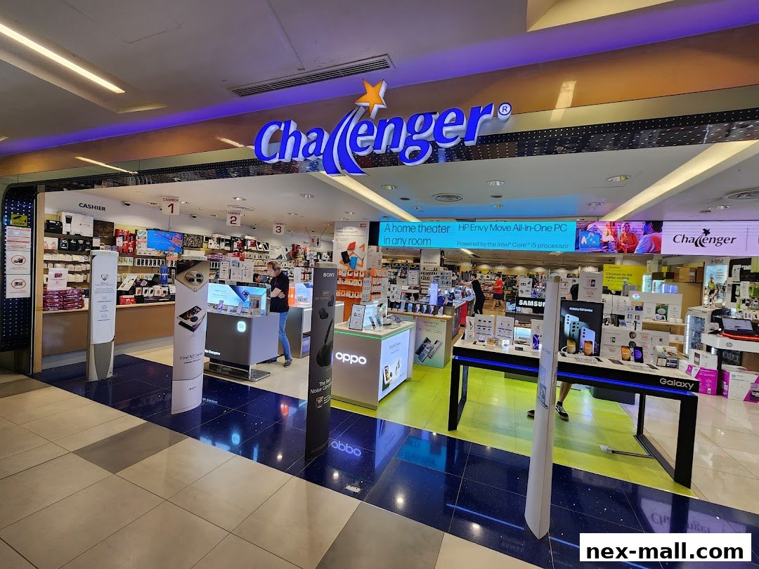 The entrance of Challenger NEX electronics store, showcasing various gadgets and displays.