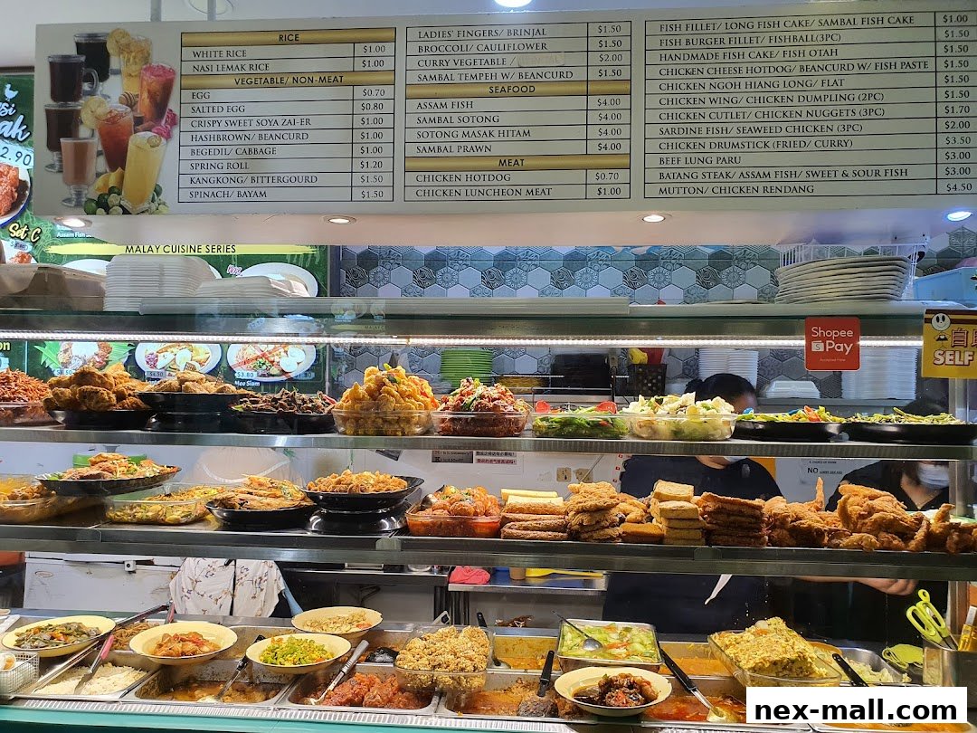 A display of various Malay cuisine dishes and drinks with prices listed on a menu board.