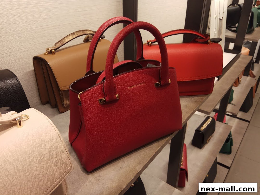 A display of various stylish handbags in different colors and sizes on shelves.