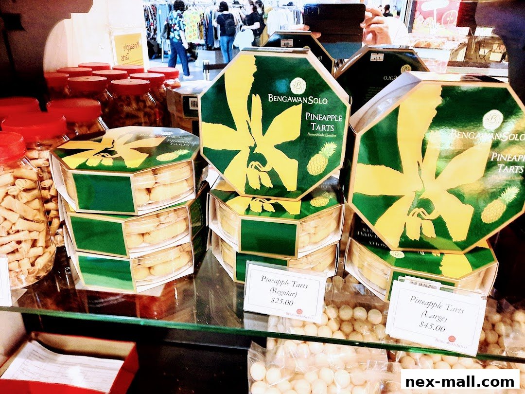 A display of hexagonal boxes filled with pineapple tarts and jars of snacks at Bengawan Solo.