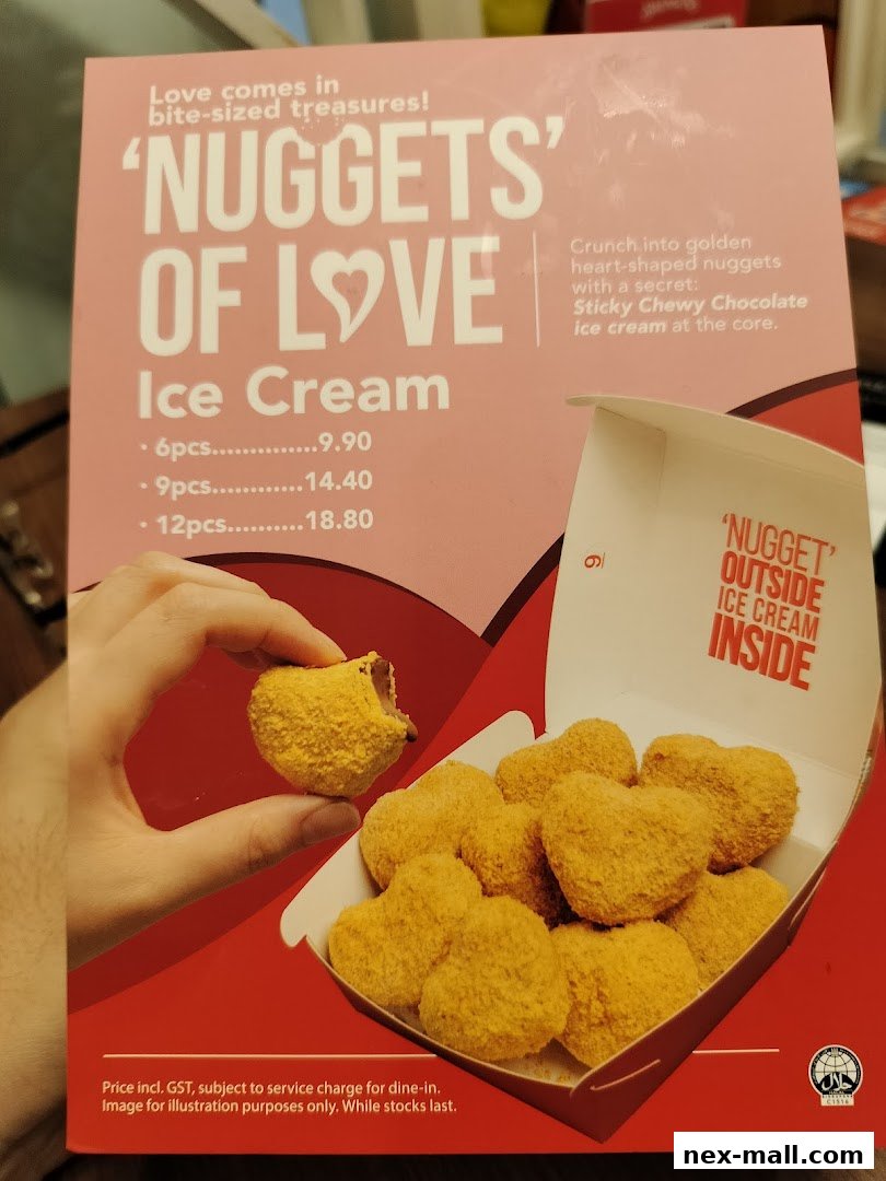 A box of heart-shaped ice cream nuggets with a hand holding one.