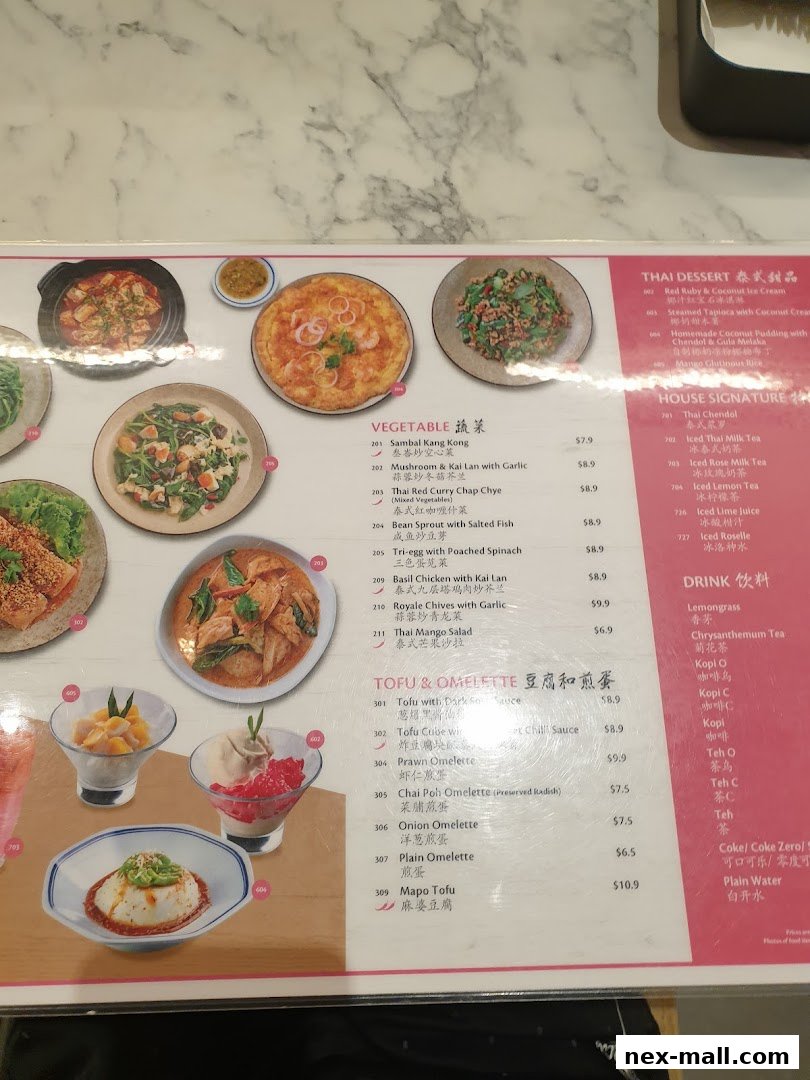 A menu from Go-Ang Pratunam Chicken Rice featuring Thai dishes, desserts, and drinks.