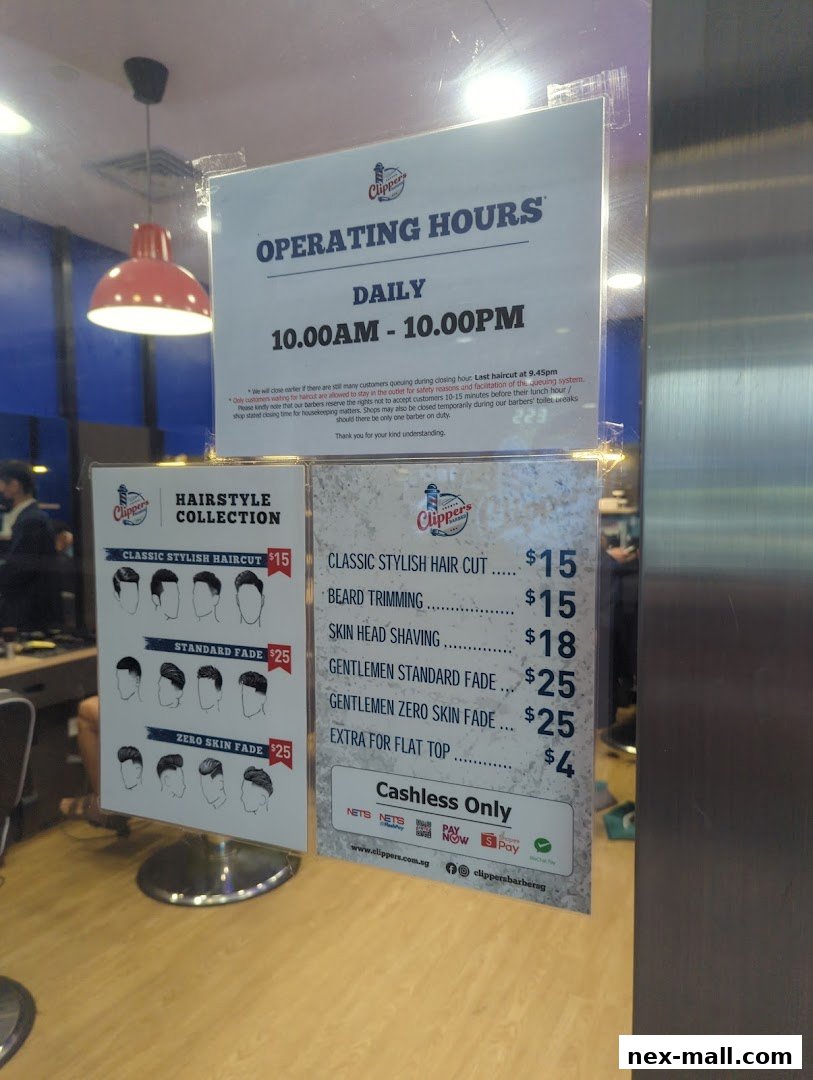 A sign displays operating hours and a price list for haircuts and beard services at Clippers Barber.