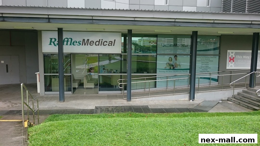 The exterior of Raffles Medical clinic with its logo and services listed on the window.
