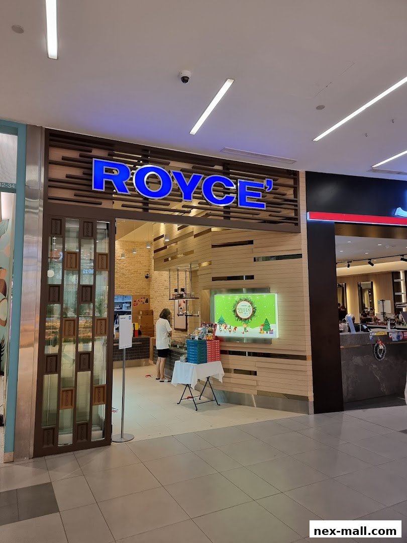The Royce shop front with its prominent blue logo and wooden accents, featuring a display of gifts.