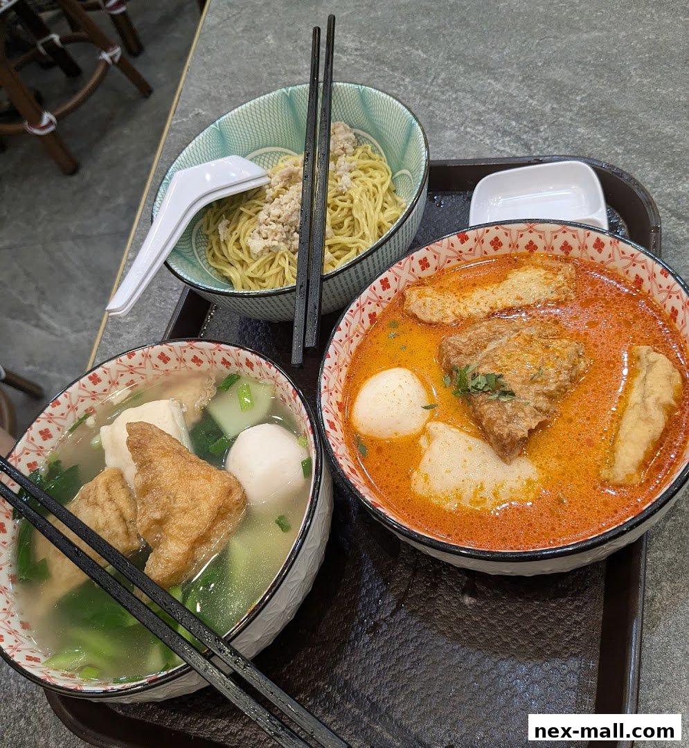 Three bowls of delicious noodles and soup with various toppings are served on a tray.