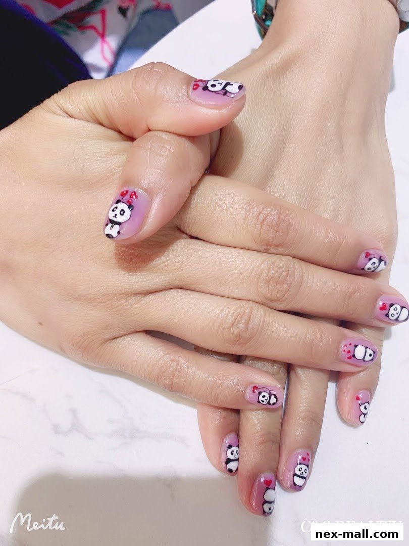 Close-up of hands with adorable panda-themed nail art.