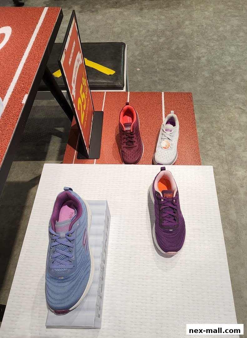 A display of Skechers athletic shoes, featuring a sale sign.