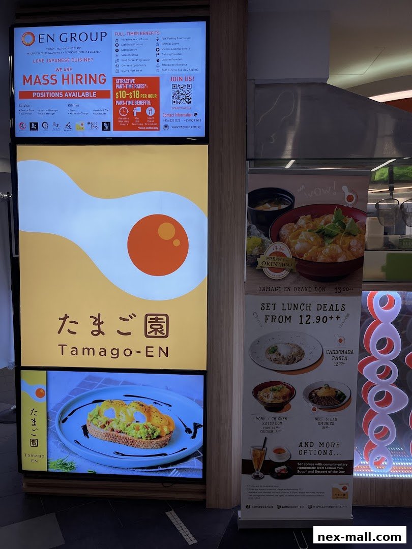 A digital display showcasing job openings and a menu for Tamago-EN, a Japanese cuisine restaurant.
