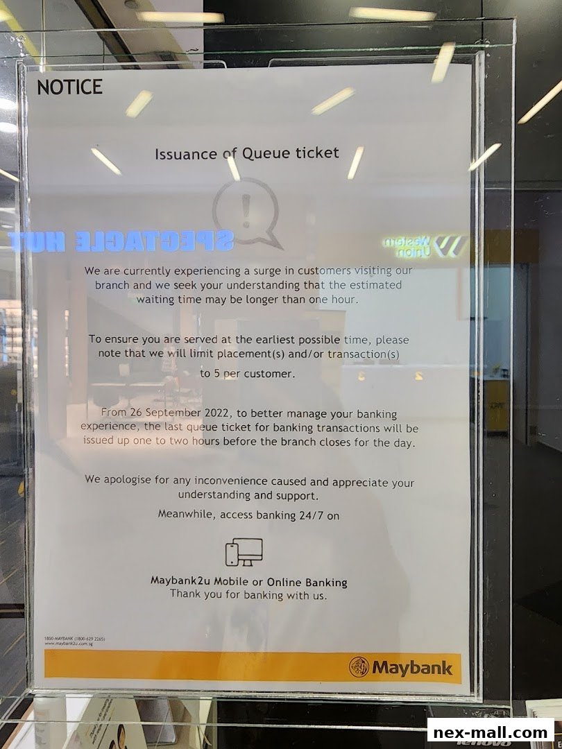 A notice about queue ticket issuance and potential longer waiting times at Maybank.