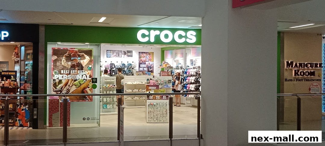 The Crocs store entrance displays colorful footwear and promotional posters.