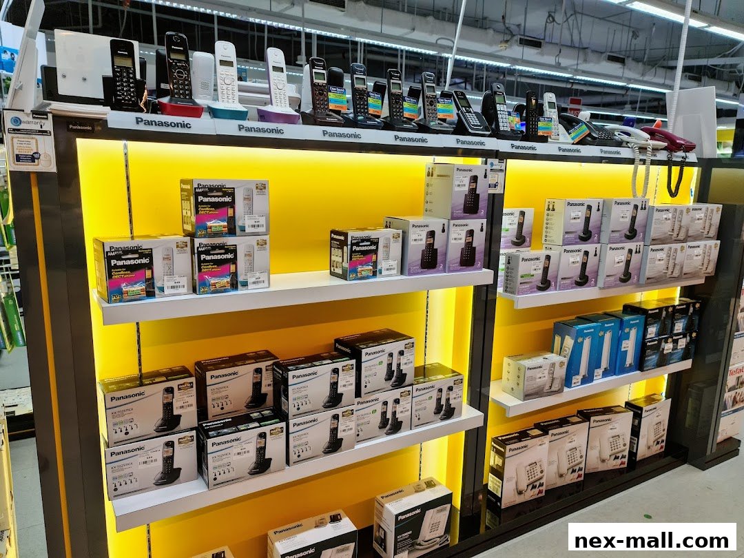 A display of various Panasonic cordless phones and landline phones on shelves.