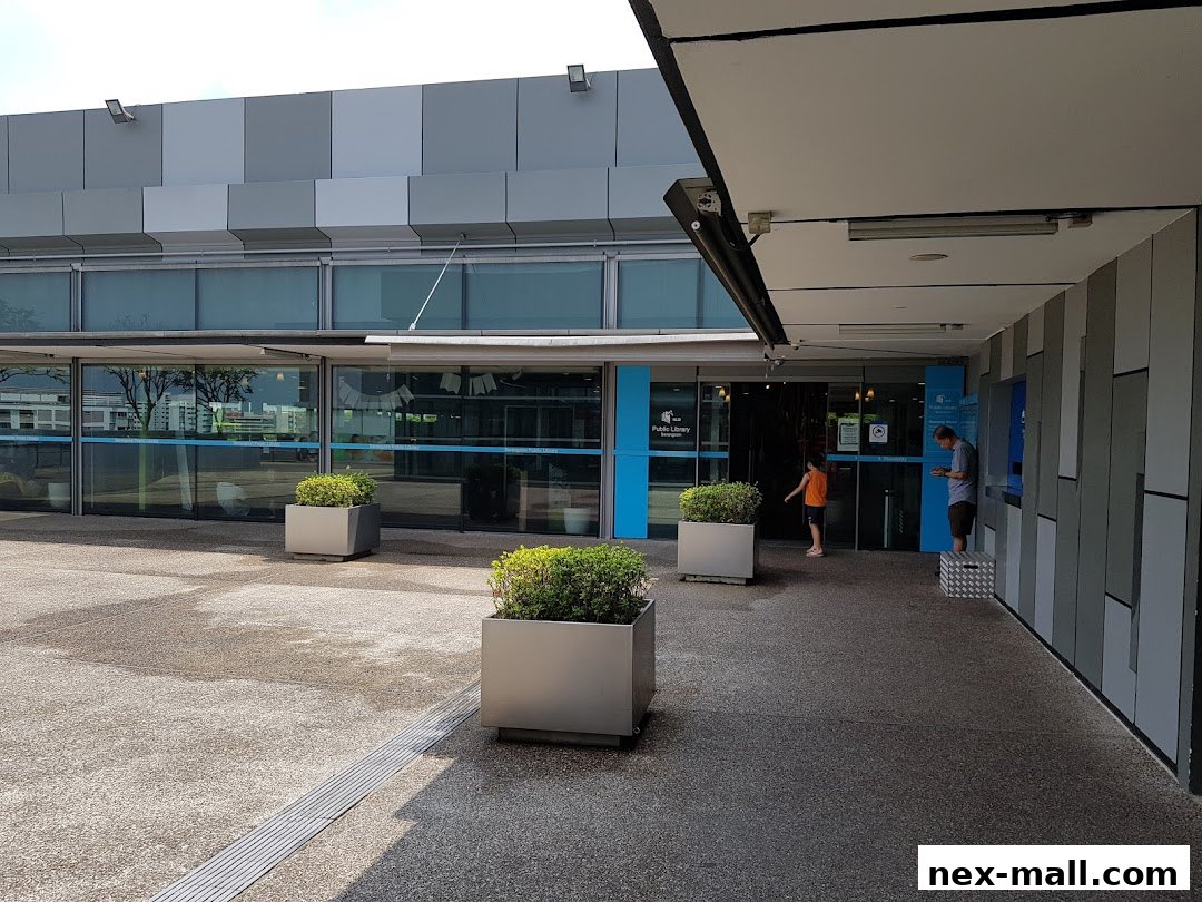 The entrance to Serangoon Public Library with people entering and exiting.