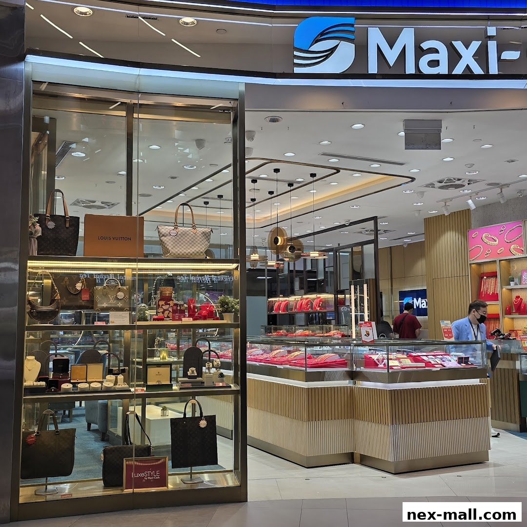 Maxi-Cash NEX Serangoon shop front displaying luxury bags and jewelry in display cases.