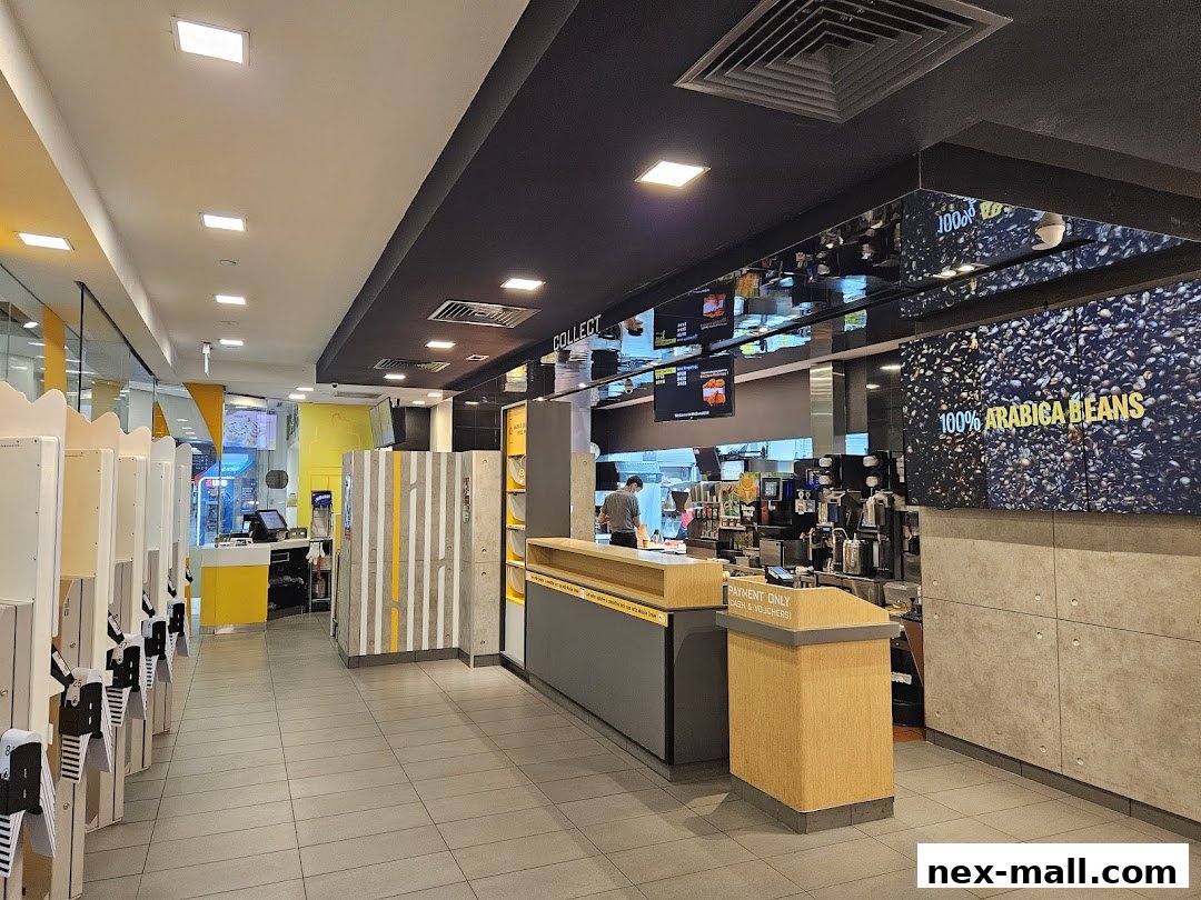 Interior view of a modern McDonald's restaurant with self-order kiosks and a service counter.