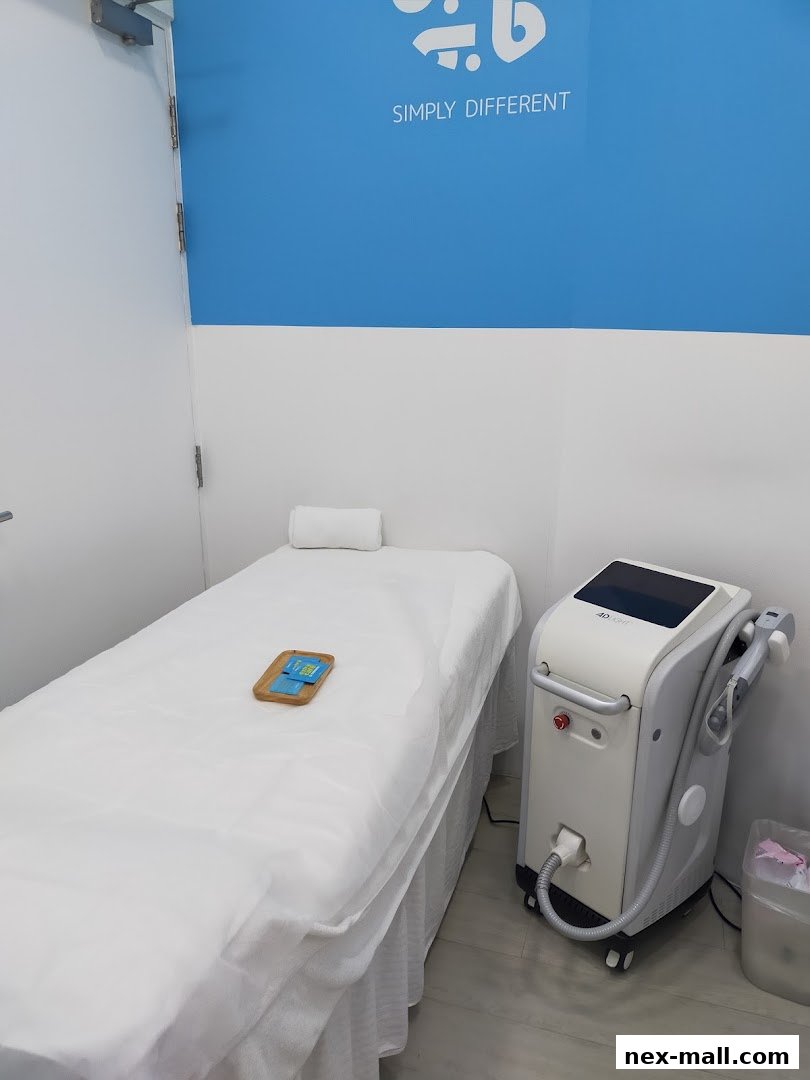A treatment bed and IPL machine in a clean, modern beauty salon.