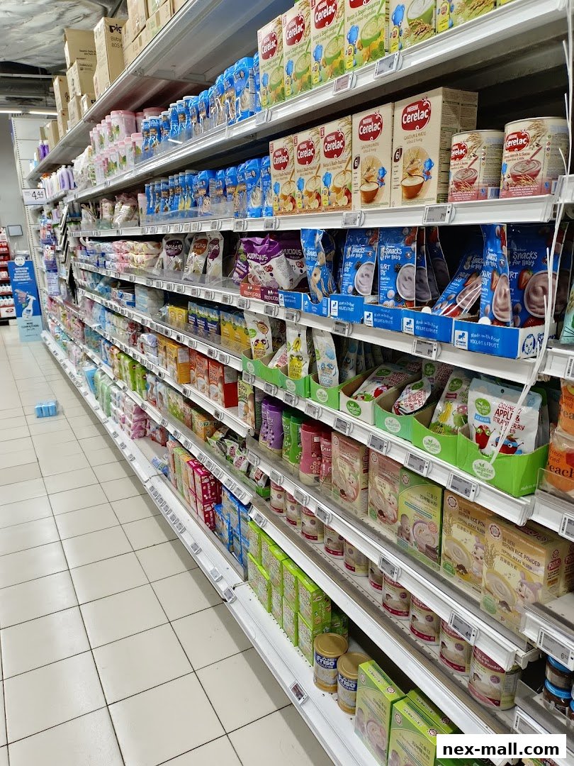 A wide aisle in a supermarket stocked with baby food and formula.