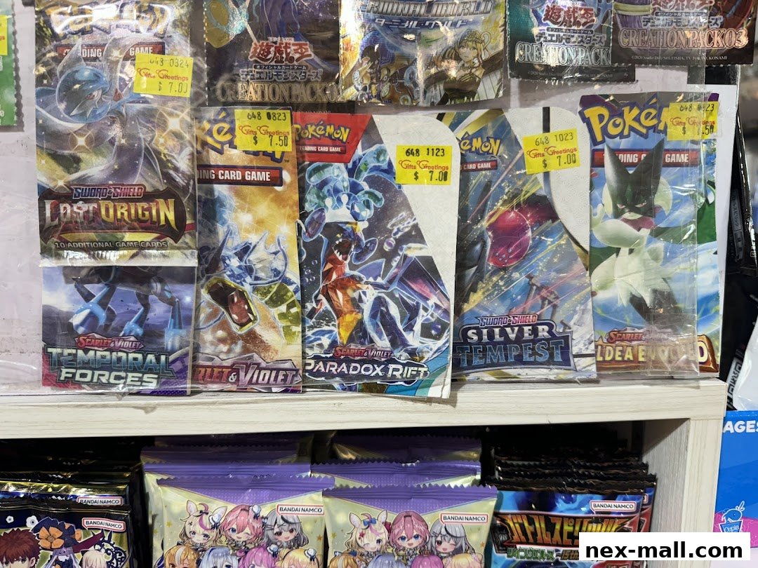Packs of trading card games, including Pokemon and Yu-Gi-Oh!, displayed on shelves.