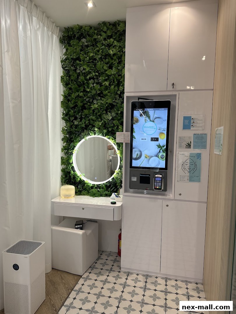 A modern beauty treatment area with a vanity, mirror, and digital kiosk.