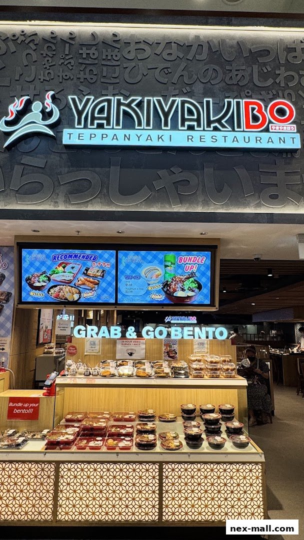 A display of Japanese bento boxes and meals at a restaurant called YAKIYAKIBO.
