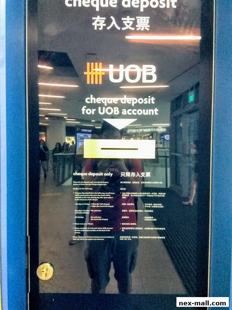 The entrance to a UOB bank branch with signage for cheque deposits.