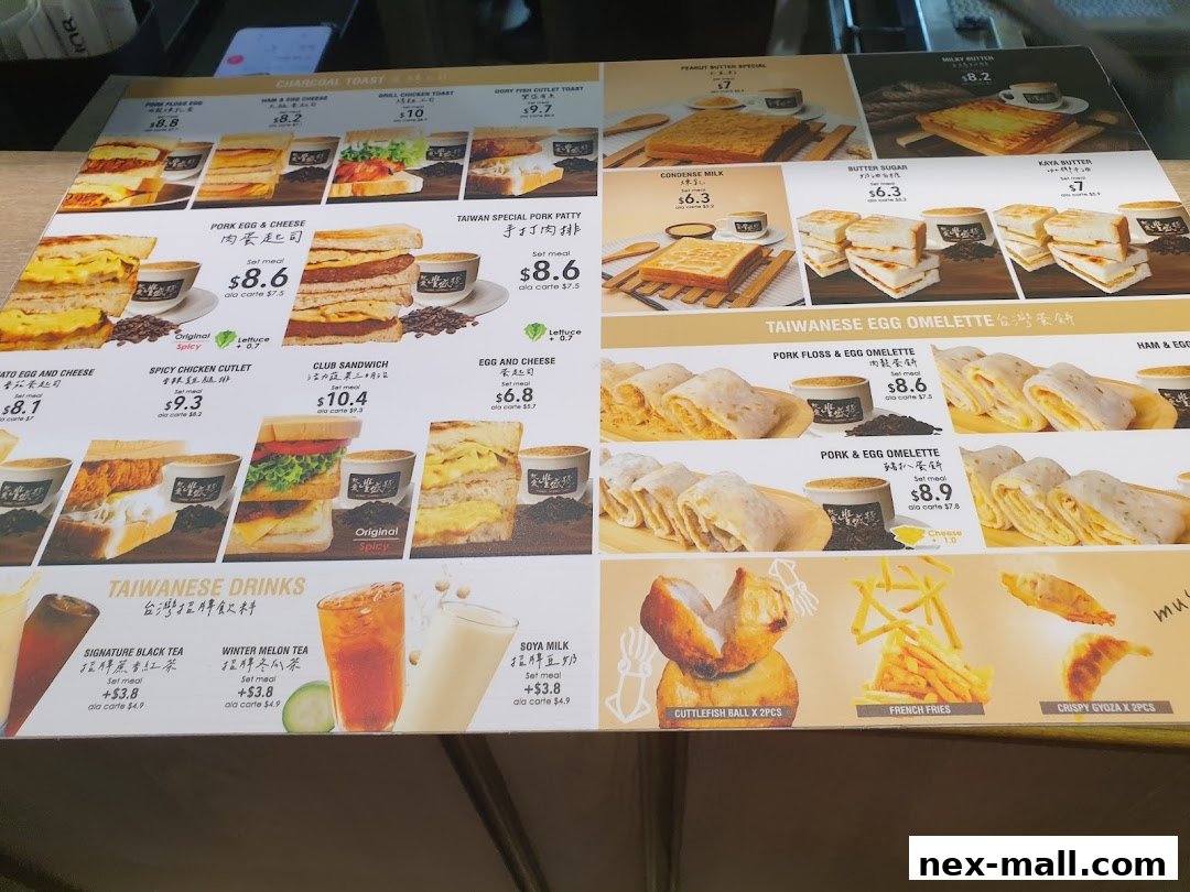 A menu board displaying various Taiwanese breakfast and snack items with images and prices.