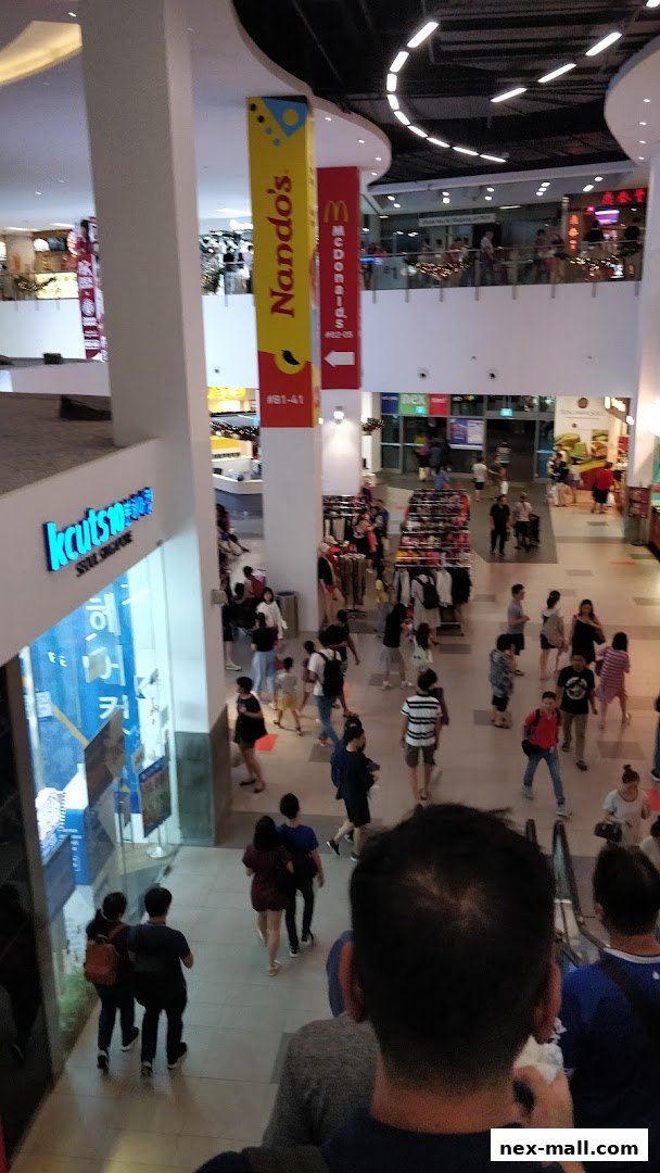 A view of the kcuts hair salon shop front in a busy shopping mall.