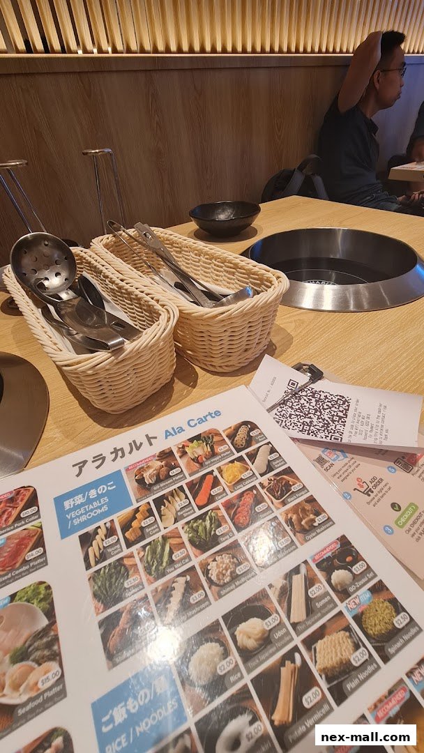 A table setting at SHABU-GOJOY JAPANESE FOOD STREET with a menu and dining utensils.