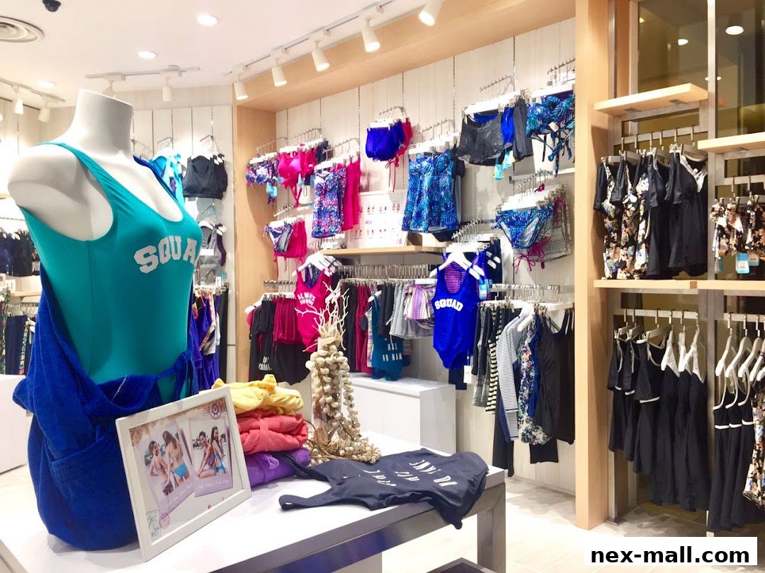 A mannequin displays a turquoise swimsuit with 'SQUAD' text, surrounded by swimwear and clothing.