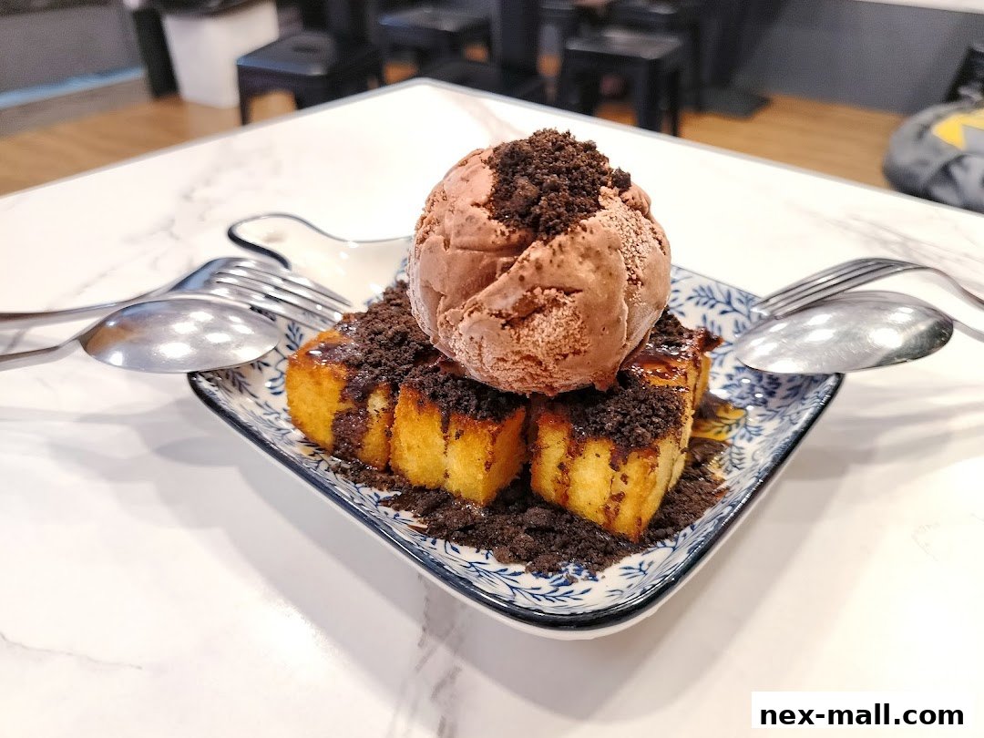 A delicious dessert featuring toast, ice cream, and cookie crumbs on a decorative plate.