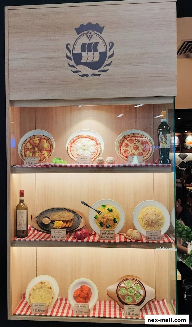 A display case showcasing realistic food models of pizzas, steak, pasta, garlic bread, chicken wings, and escargots.