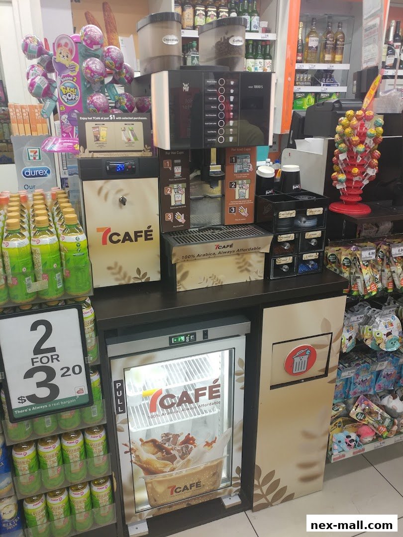 A 7-Eleven store display featuring a coffee machine, drinks, and snacks.