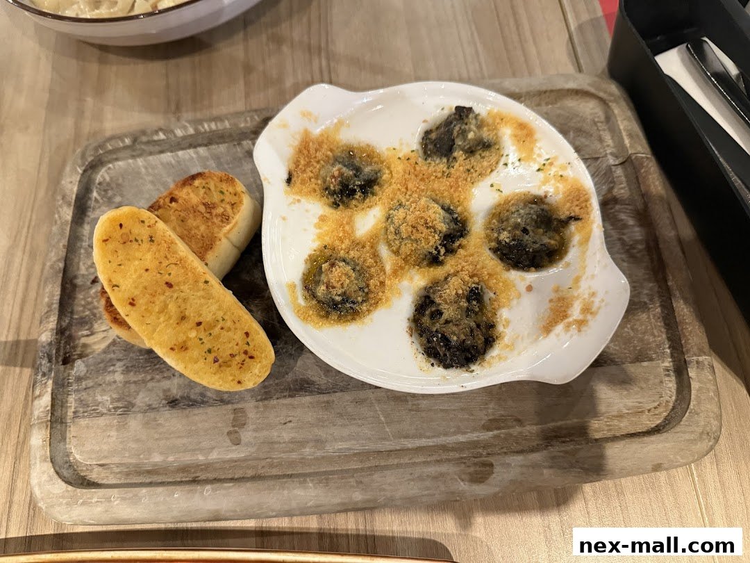 A dish of escargots with garlic bread on a wooden board.