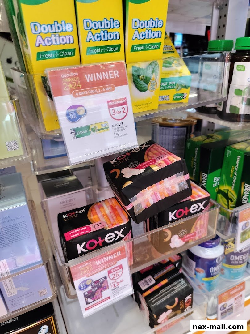 A display of feminine hygiene products and toothpaste with promotional signage.